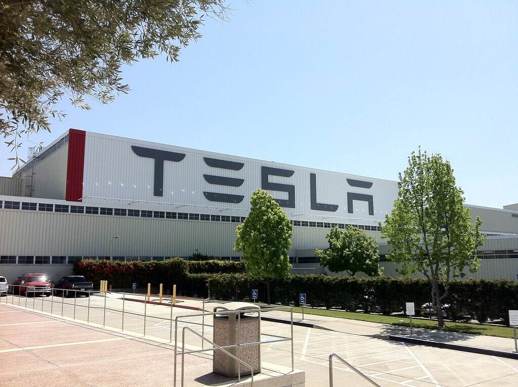 tesla posts strong sales but profit declines