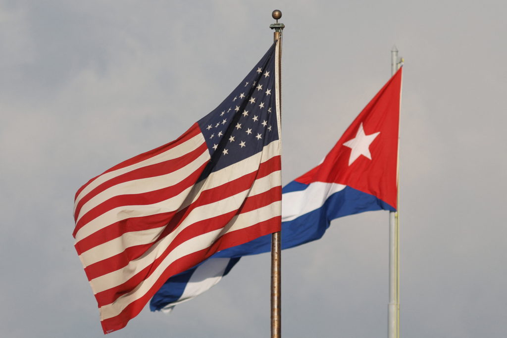 a view of cuban and u.s. flags beside the u.s. embassy in havana