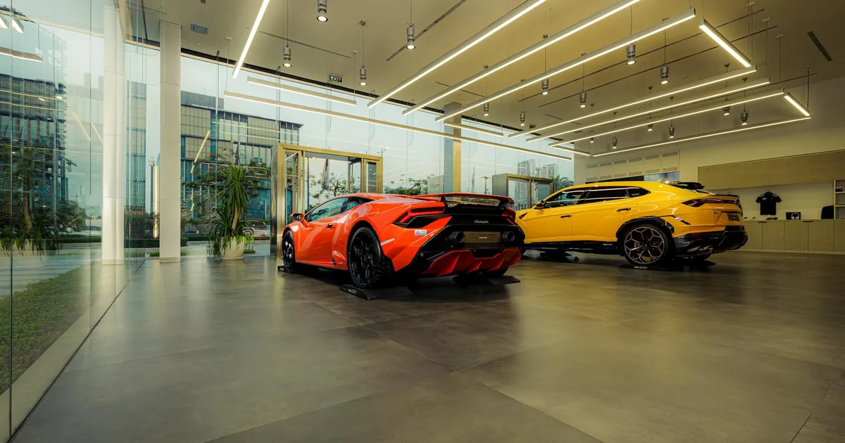 Showroom featuring luxury sports cars, Lamborghini models, with sleek design and modern architecture.
