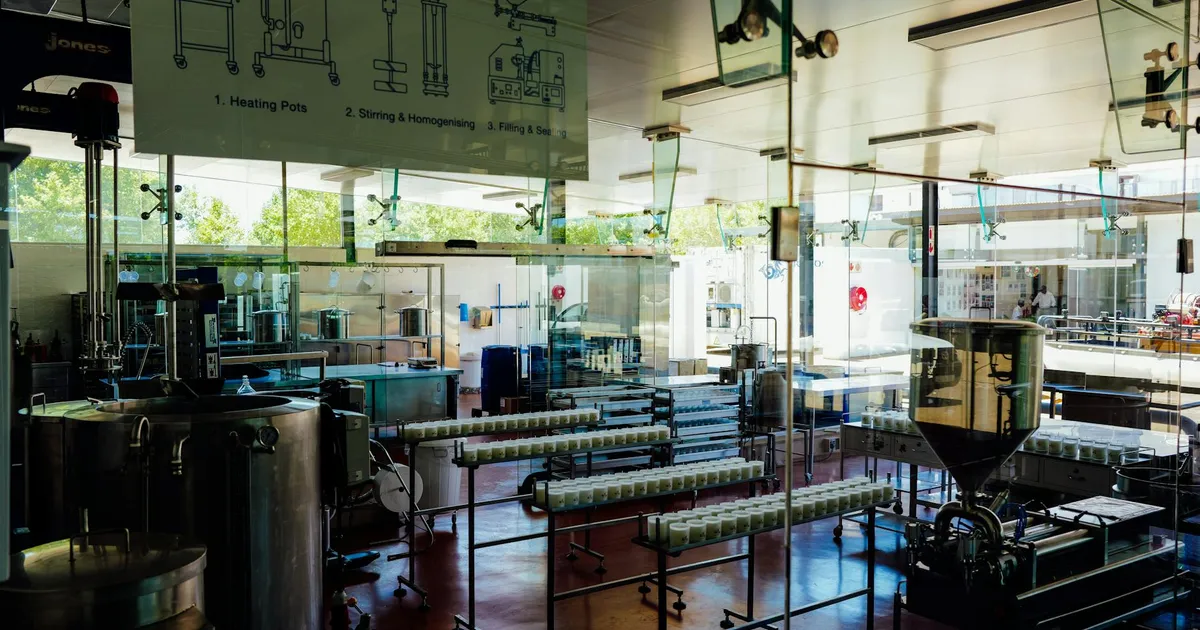 Spacious and modern food production plant interior with industrial machinery and processing line.