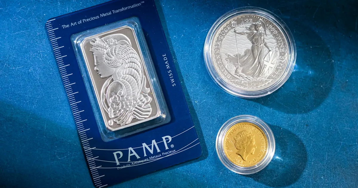 Silver bar and coins on blue surface, highlighting investment and collectible value.