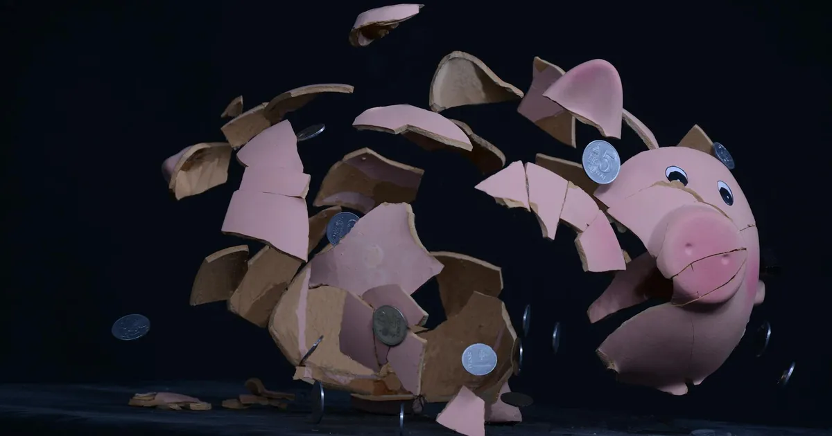 High-speed capture of a piggy bank shattering with coins scattering in mid-air.