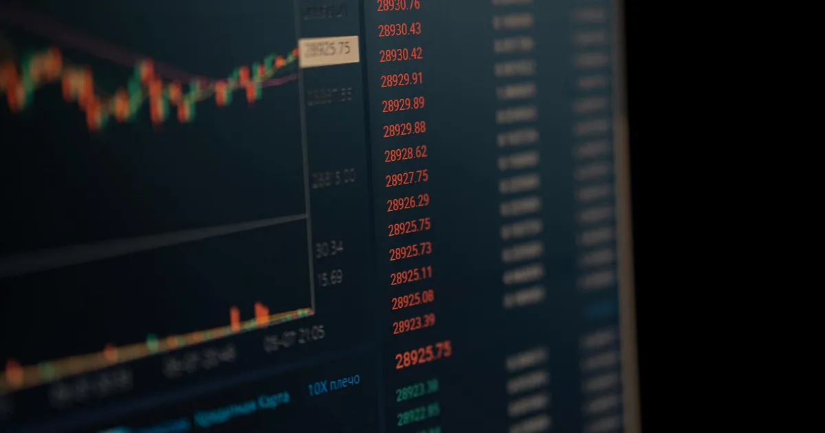 Close-up of a computer screen showing dynamic financial market data and charts, indicating real-time trading updates.