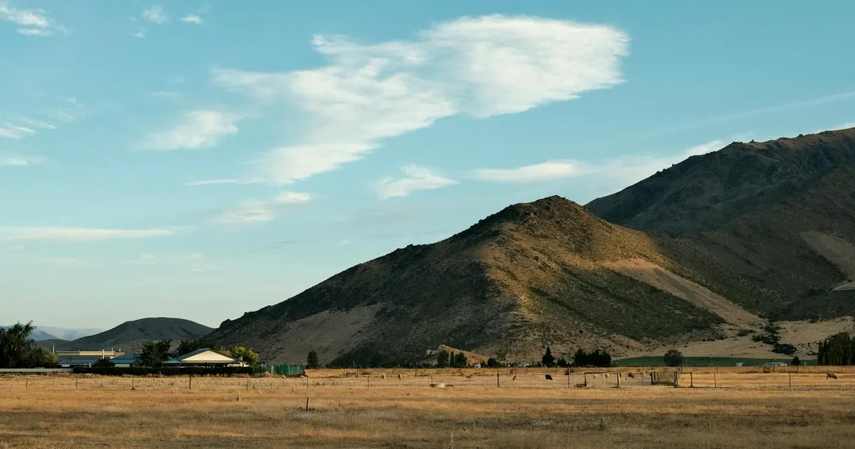 Stunning view of hills and clouds in Omarama, New Zealand countryside.