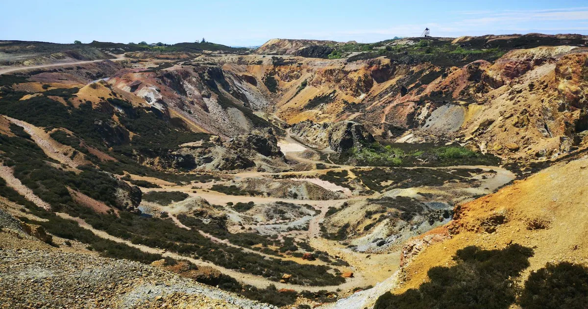 Vibrant aerial view of Parys Mountain's historic copper mine in Wales showcasing rugged geological formations.