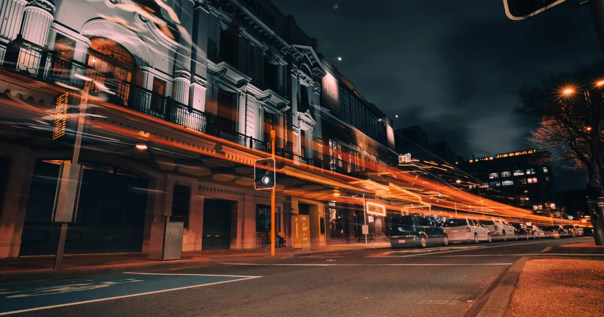 Vibrant city life in Wellington captured with stunning light trails on a bustling street at night.