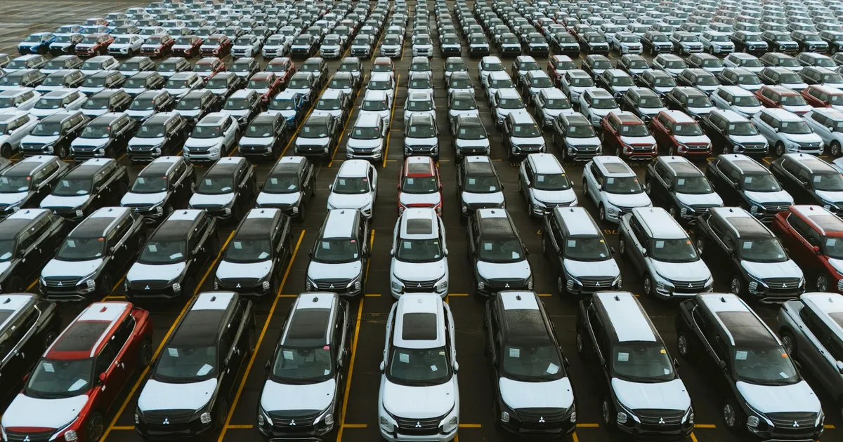 Aerial shot showcasing a vast storage lot filled with parked cars lined up in rows.