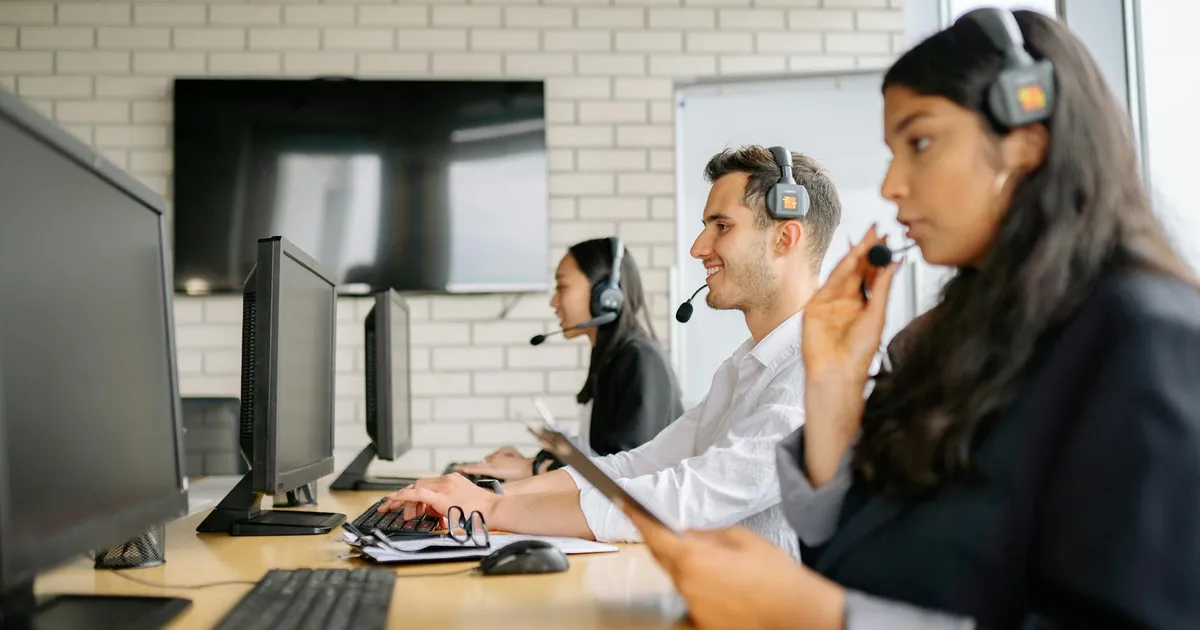 Diverse group of call center agents working together in a modern office environment.