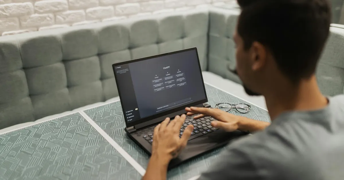 A man working on a laptop in a cozy, modern office space with a focus on technology.