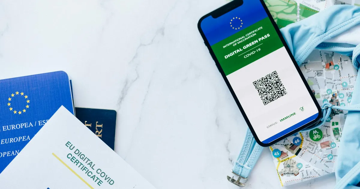 EU digital COVID certificate with smartphone, passports, and map symbolizing travel and vaccination support.