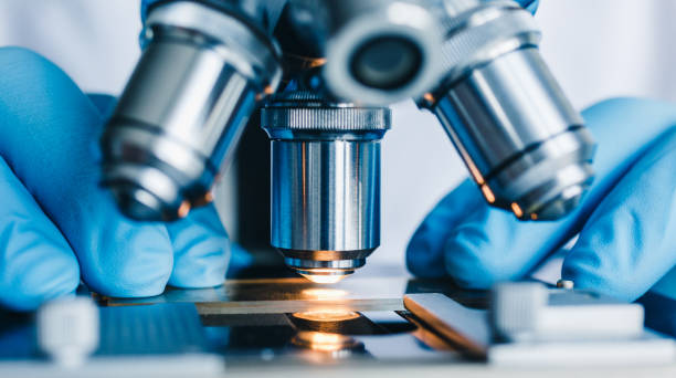 close up shot of microscope with metal lens at laboratory.