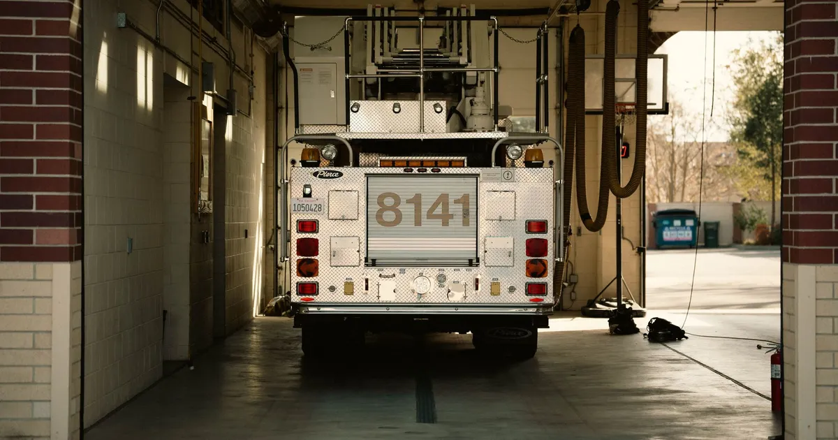 A fire truck parked inside a station's garage, showcasing emergency preparedness.
