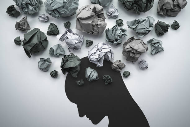 concept image of anxiety and negative emotion. waste paper and head silhouette.