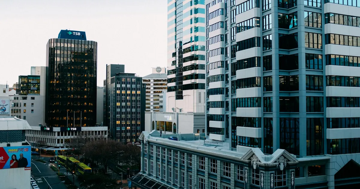 A bustling urban skyline with modern skyscrapers and city streets during the day.
