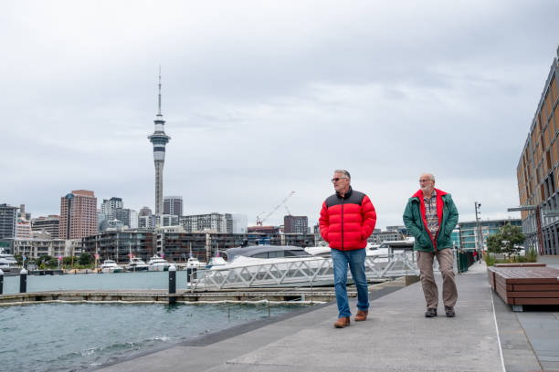 two mature males walking along the waterfront of auckland city