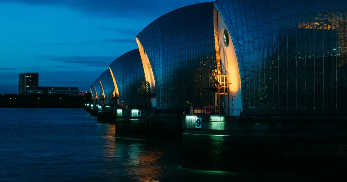 A vibrant evening shot of the Thames Barrier in London, highlighting modern architecture and warm lighting.
