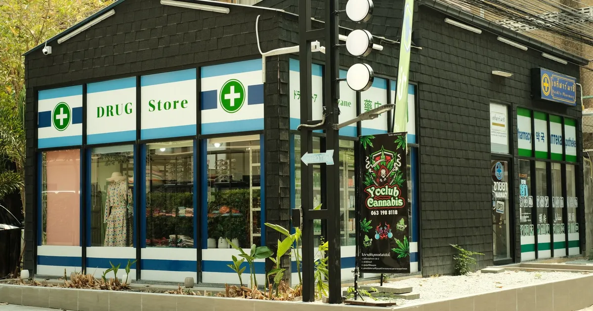 Modern urban drug store with cannabis signage and green exterior plant decor.
