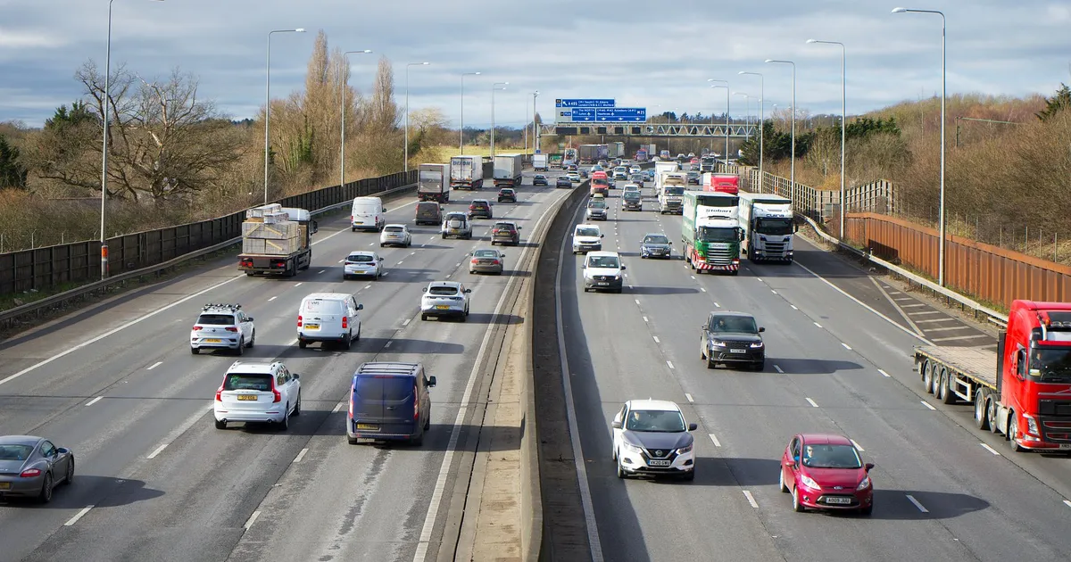 View of cars and trucks on a busy highway in St Albans, UK during daytime.