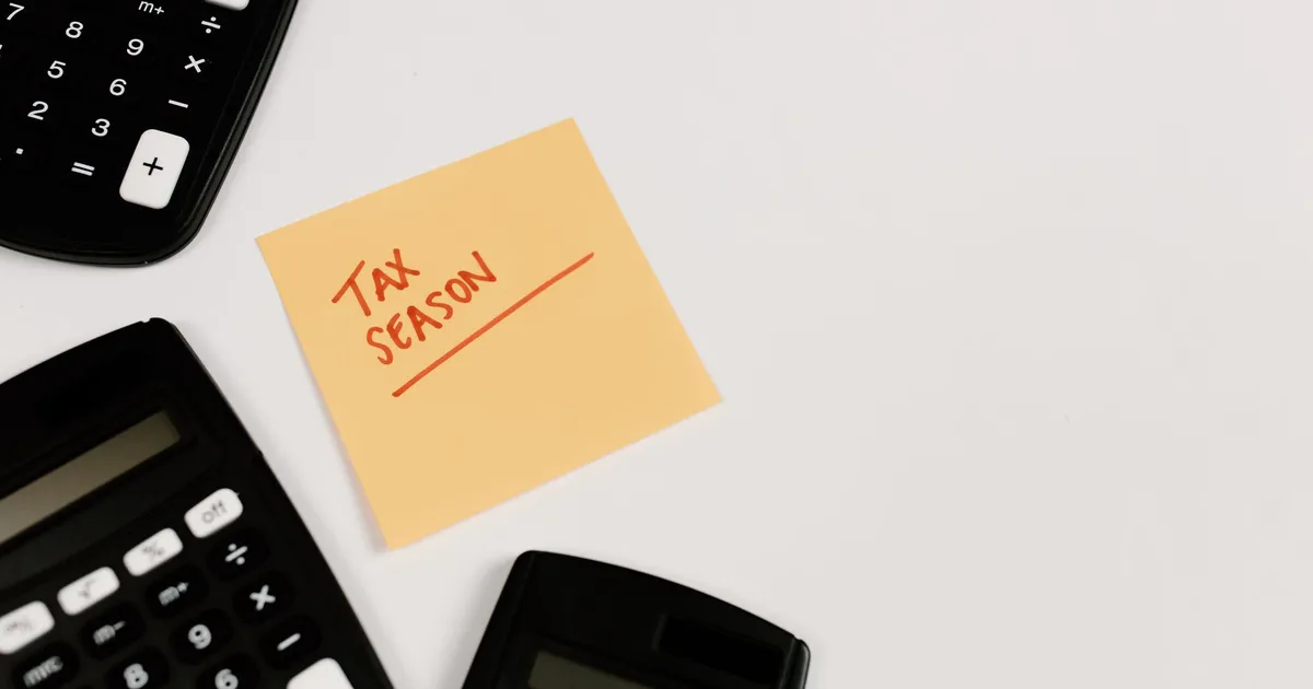Calculators and sticky note labeled 'Tax Season' on white background, ideal for financial themes.