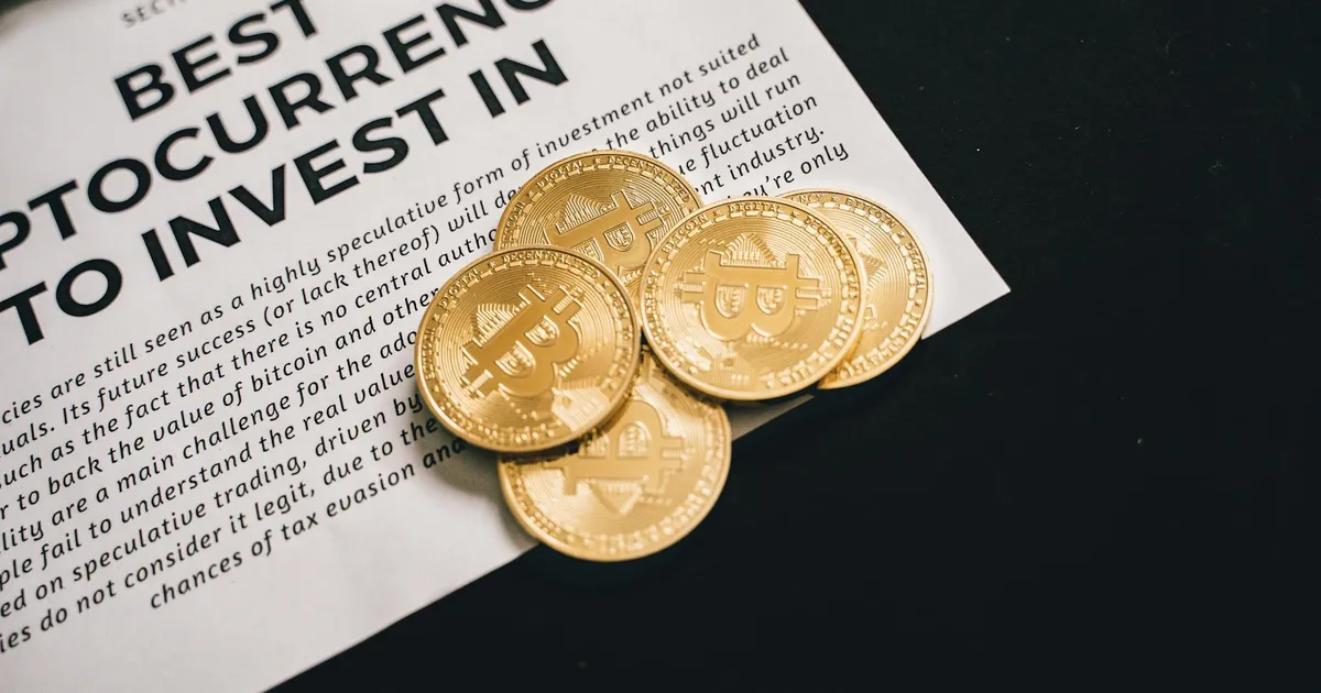 Close-up of Bitcoin coins on investment document promoting cryptocurrencies.