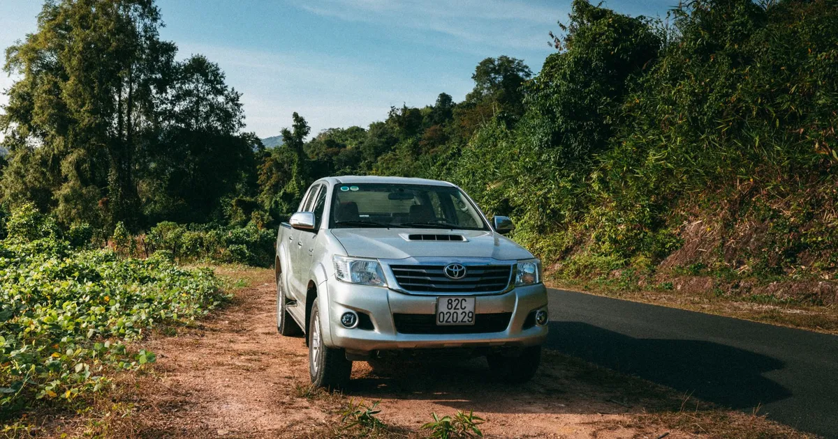 Explore Vietnam's rustic charm with an off-road vehicle amidst lush greenery in Kon Tum.