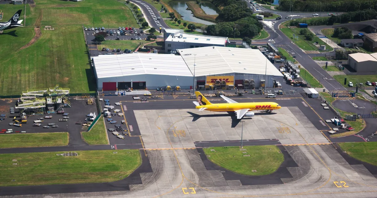 Aerial photo showcasing DHL airplane and hangar facilities in a busy airport setting.