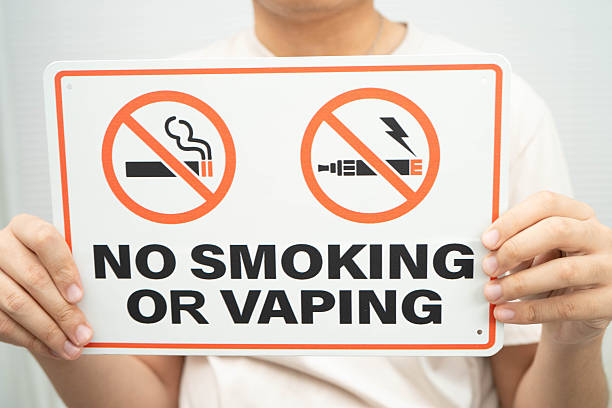 male holding a no smoking or vaping sign.