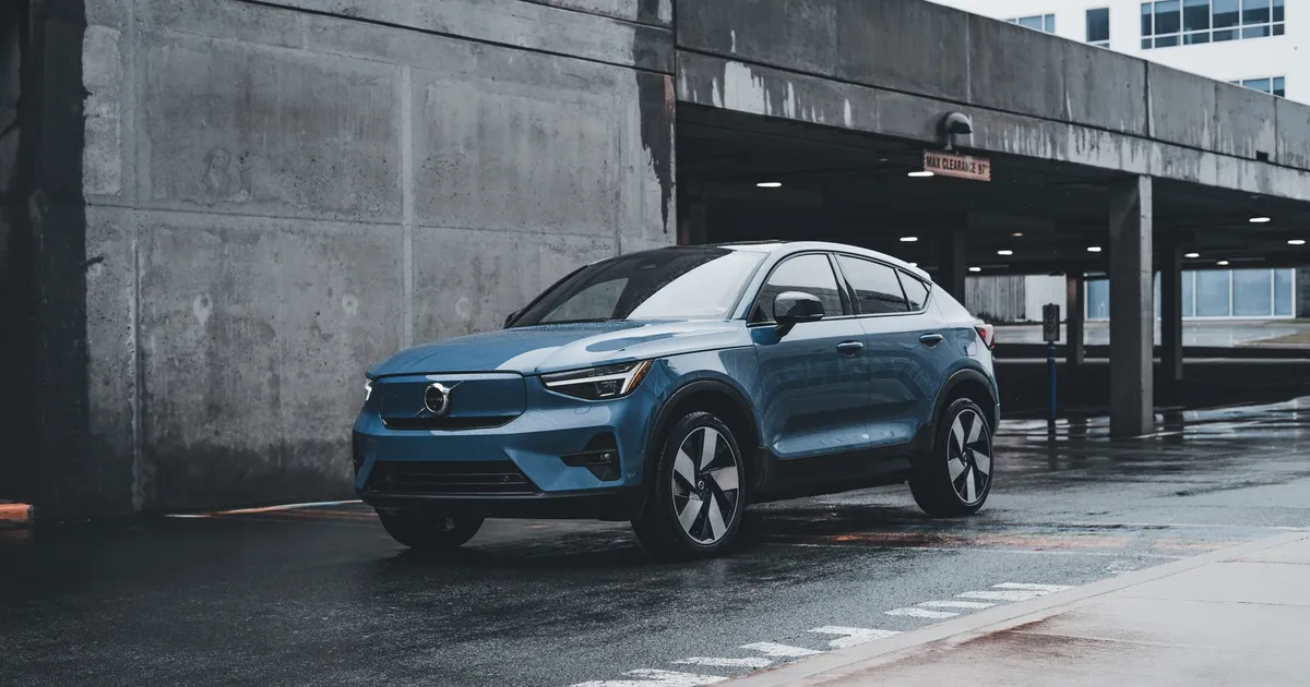 Blue Volvo SUV parked in a modern urban environment showcasing sleek design and urban lifestyle.