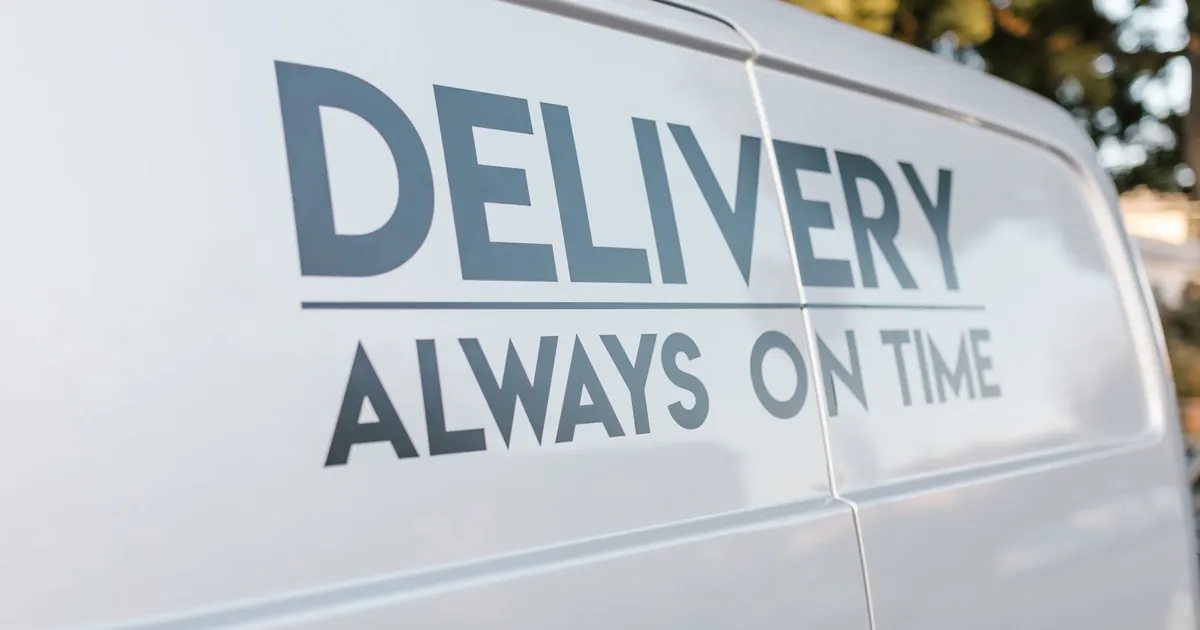 Close-up of delivery van with slogan 'Always On Time' emphasizing timely service.