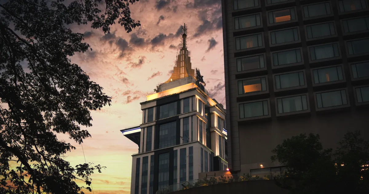 A stunning view of Bengaluru's skyline at dusk, highlighting a distinctive tower against a vibrant sky.