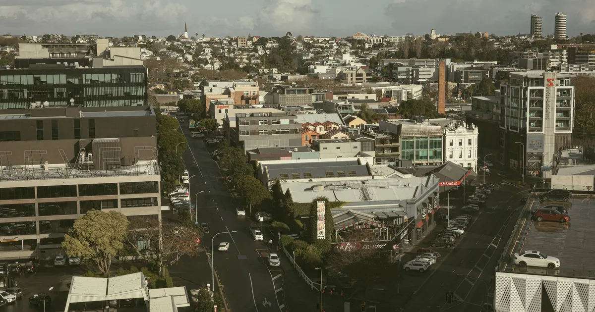 Aerial view of modern cityscape in Auckland, showcasing streets and architecture.