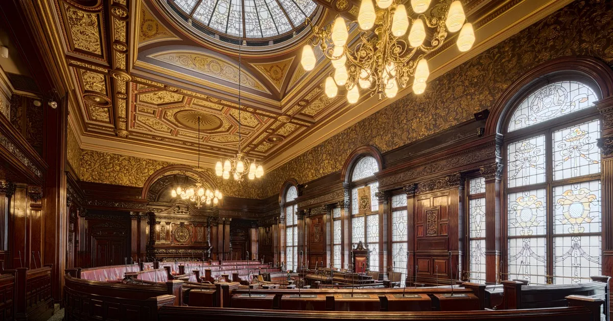 Elegant interior of Glasgow City Chambers featuring intricate details and stained glass windows.