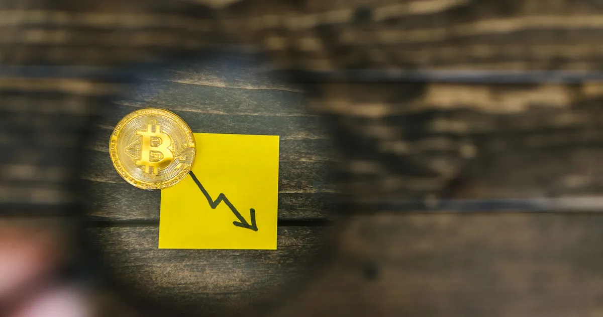 A gold Bitcoin and downward trend arrow symbolizing cryptocurrency market decline.