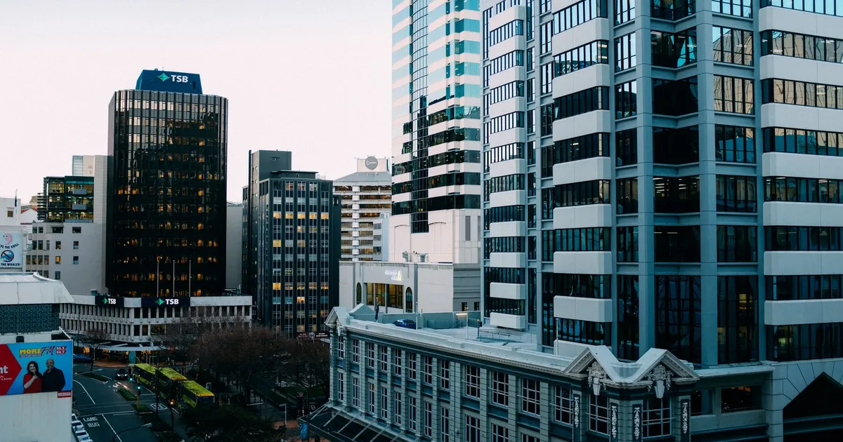 A bustling urban skyline with modern skyscrapers and city streets during the day.