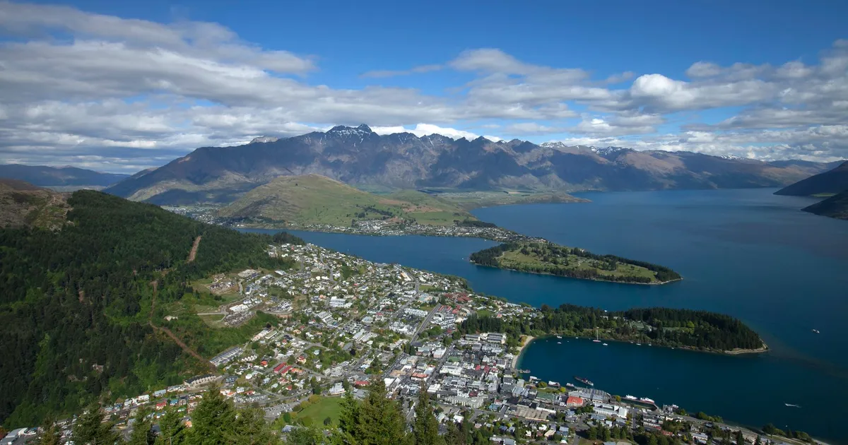 A breathtaking aerial view of Queenstown, New Zealand, overlooking Lake Wakatipu and surrounding mountains.