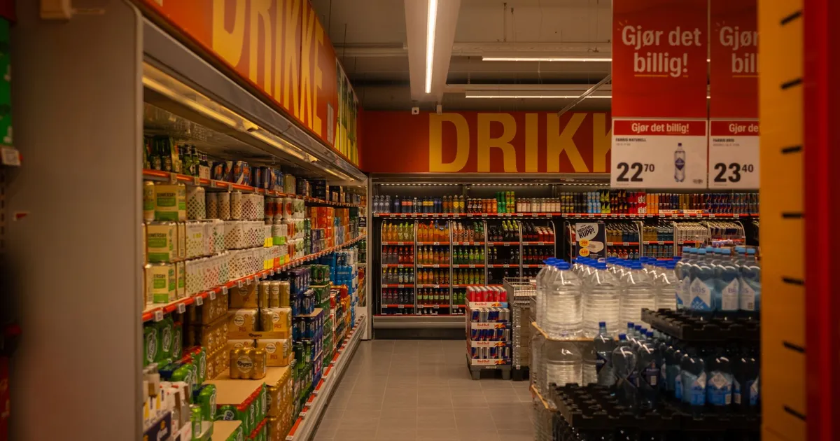 Colorful drink aisle in a supermarket with signage promoting deals.