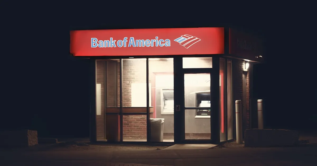 Illuminated Bank of America ATM structure against a dark nighttime backdrop in Boston.