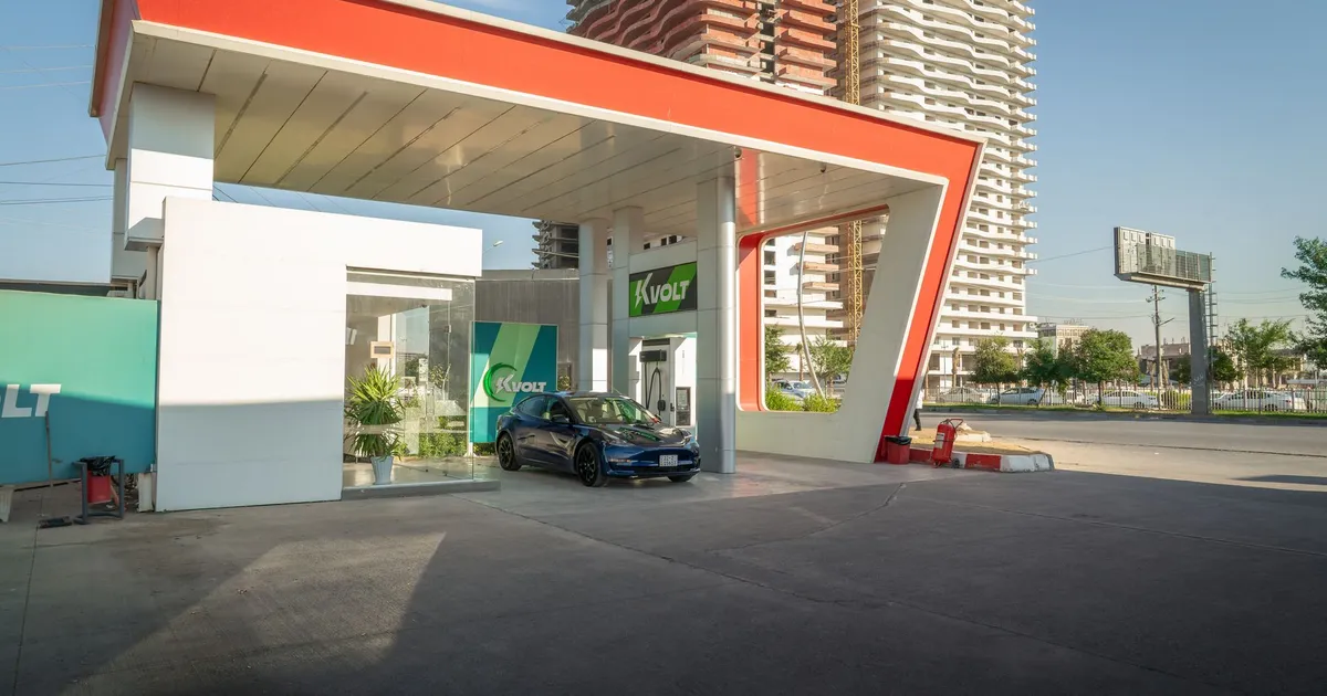 Electric vehicle at a modern charging station in an urban setting, promoting sustainability.