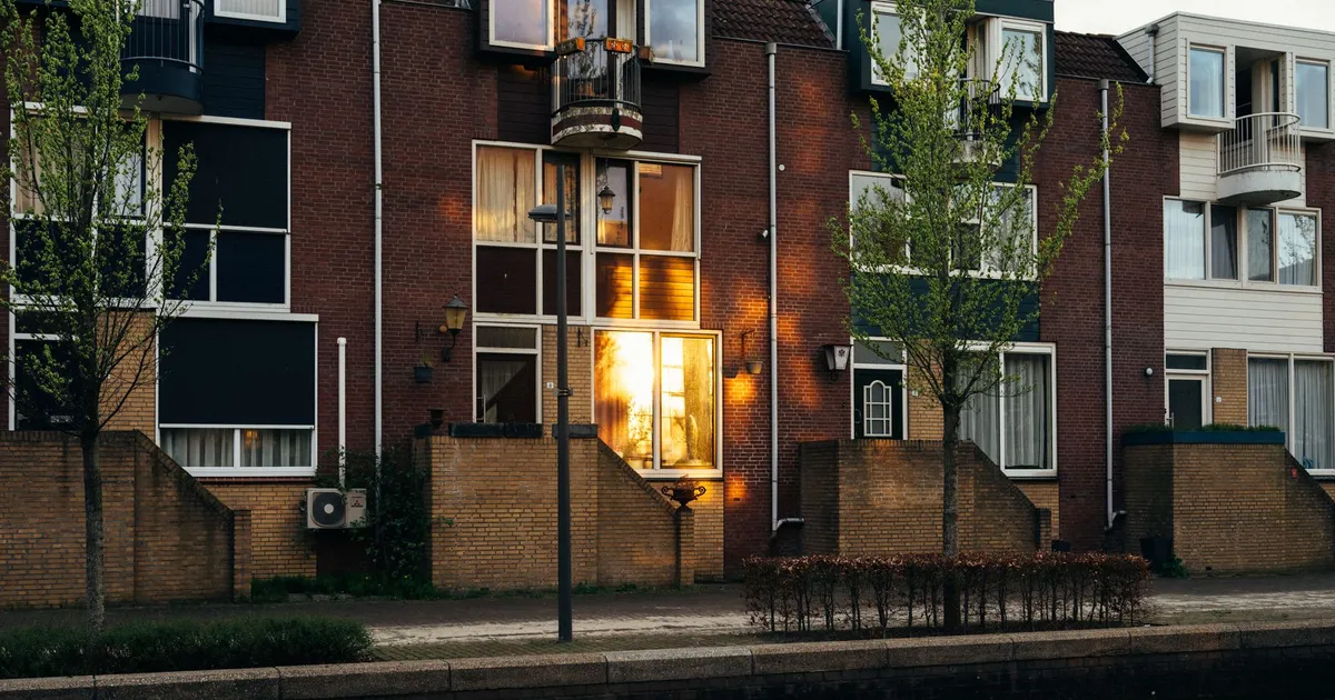 Charming sunset reflection on modern Dutch townhouses in Almere, Netherlands.