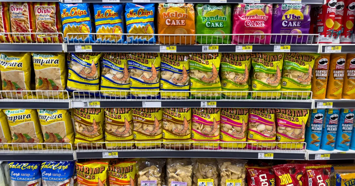 Colorful snack packages neatly displayed in a supermarket aisle showcasing Asian food variety.