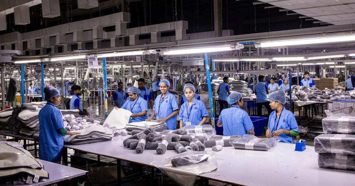 Indian textile factory workers expertly packaging products on an assembly line.