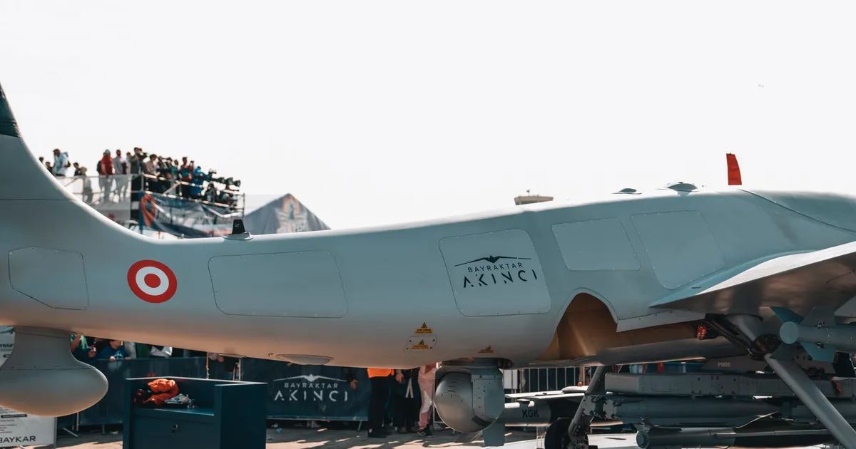 Bayraktar Akinci drone displayed at a busy airshow with spectators.