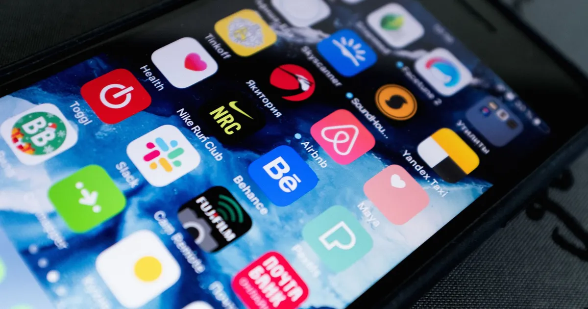 Detailed view of smartphone displaying multiple app icons on screen, highlighting technology use.