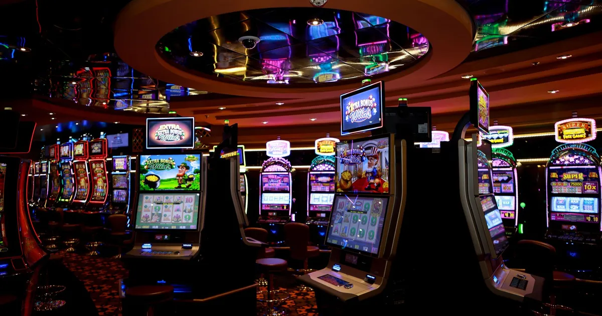 Vibrant casino floor with colorful slot machines and bright lights capturing a lively gaming atmosphere.