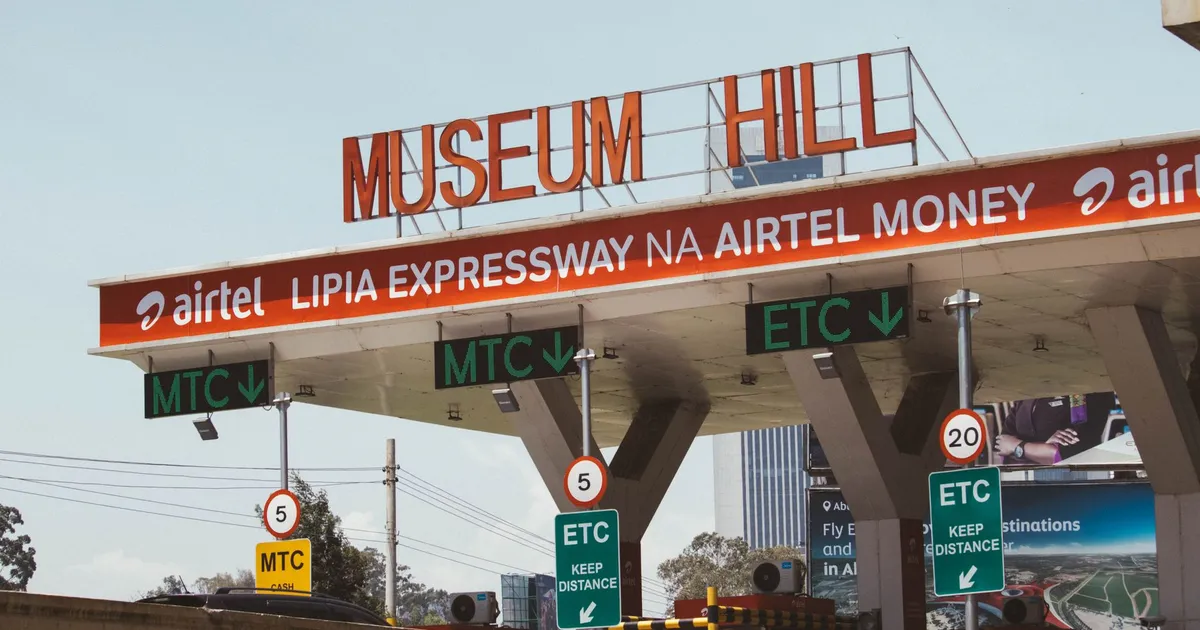 View of Museum Hill toll plaza in Nairobi, Kenya, displaying road signs and payment options.