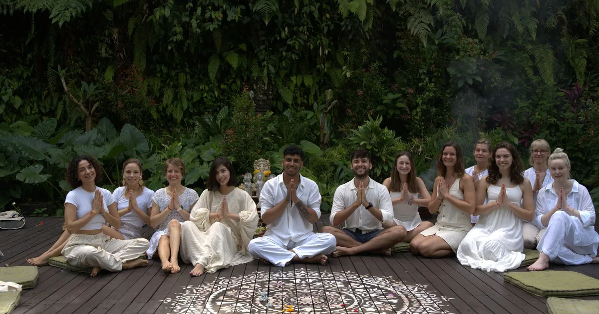 A diverse group practicing yoga outdoors, fostering unity and relaxation in nature.