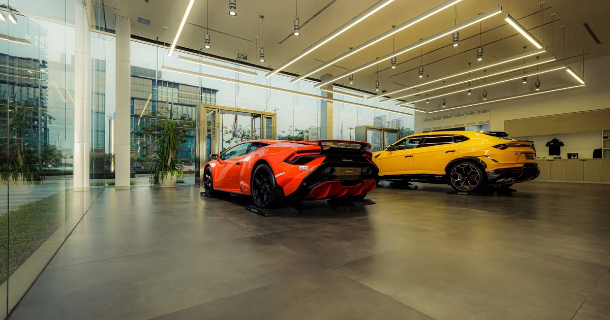 Showroom featuring luxury sports cars, Lamborghini models, with sleek design and modern architecture.