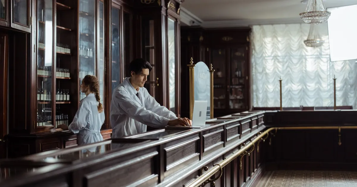 Pharmacists working in a vintage pharmacy setting with old-fashioned decor.