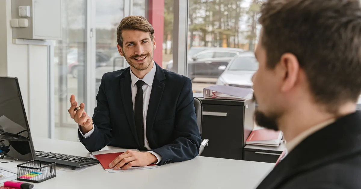 Two businessmen having a conversation in a modern office setting.