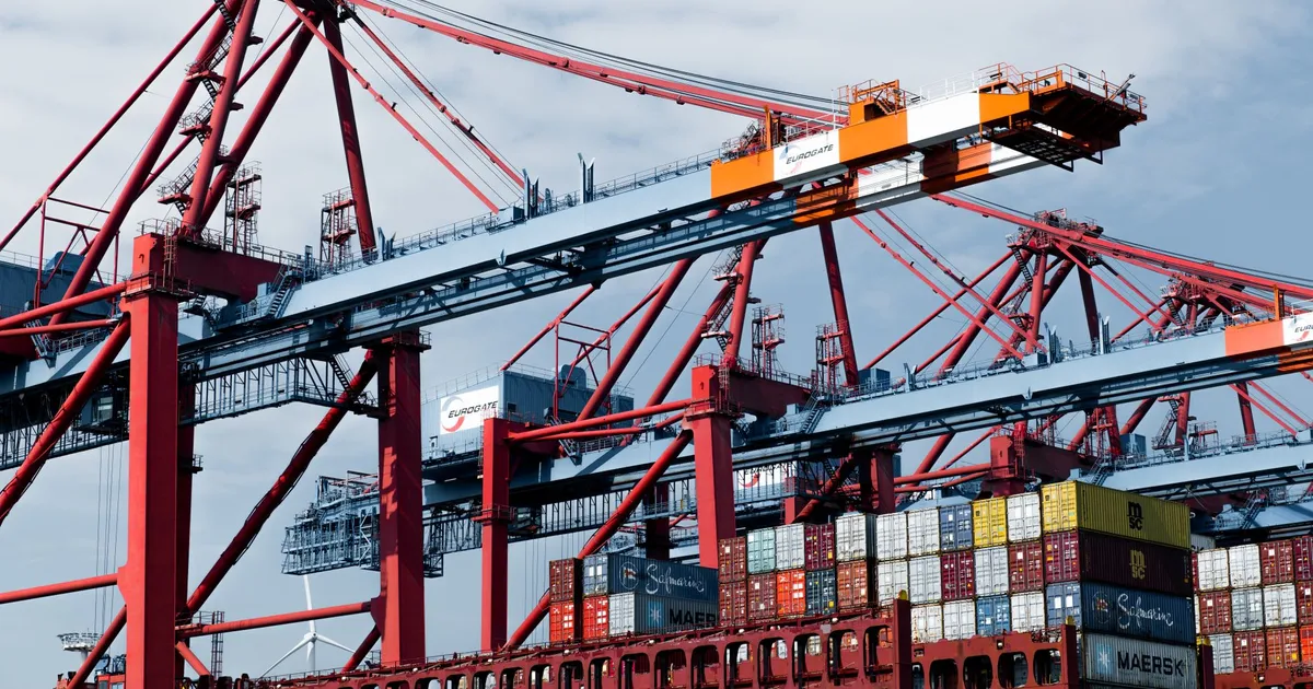 Cranes and shipping containers at Hamburg port, a hub of industry and trade.